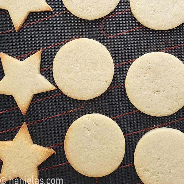 Star and round cookie on a perforated mat.