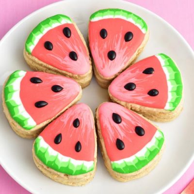 Watermelon pinata cookie arranged in a circle on a plate.