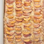 Baked peach streusel bread in a baking pan.