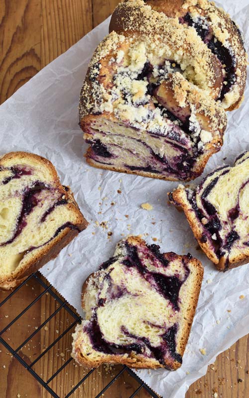 Baked sliced babka showing streusel topping and filling.