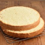 Sliced sponge cake on a cooling rack.