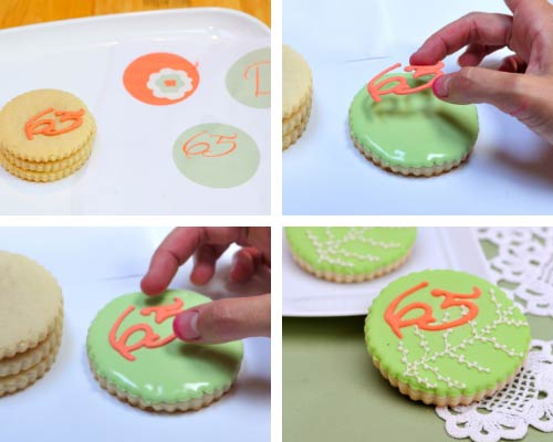 Applying royal icing transfer onto wet royal icing.