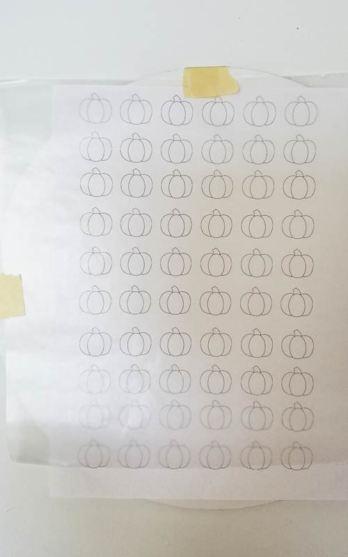 Template with a wax paper placed over it and secured with a masking tape.