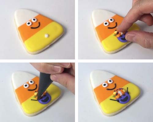 Attaching royal icing basket decoration on a candy corn cookie.