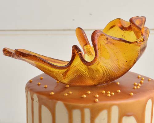 Detail of caramel sail decoration on top of the cake.