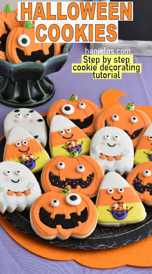 Pumpkin, Ghost and Candy Corn cookies displayed on a black plate.