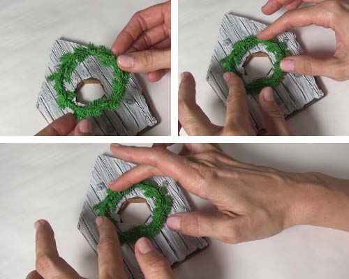 Attaching royal icing wreath on a cookie.