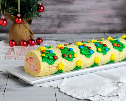 Cake roll displayed on a white tray on a table.