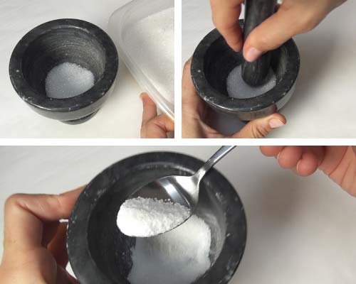 Using mortar and pestle to powderize granulated sugar.