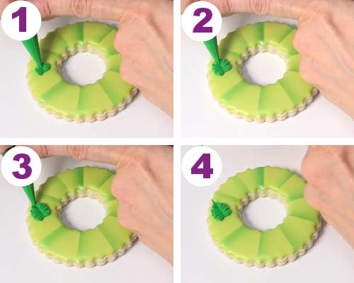 Piping a leaf with royal icing.