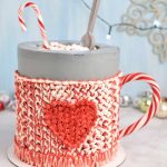 Buttercream mug cake displayed on a marble counter top/