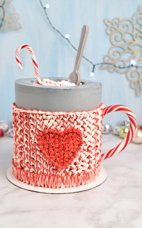 Buttercream mug cake displayed on a marble counter top.