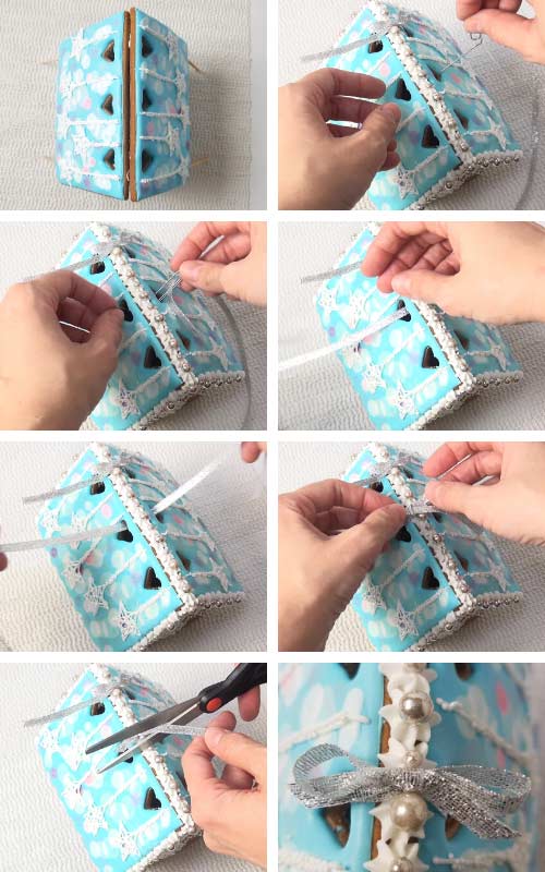 Threading a silver ribbon through gingerbread house roof cutouts and tying a bow.