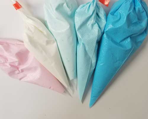 Colored royal icing in piping bags.