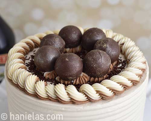 Chocolate spheres on top of the cake.