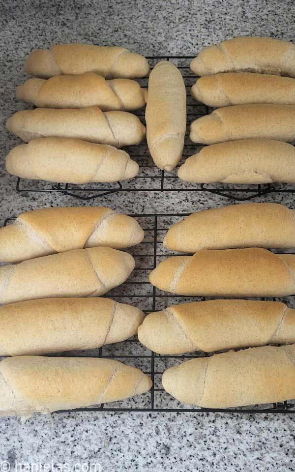 Baked buns on a cooling rack.