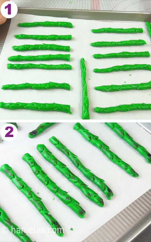 Painted cookies on a baking sheet lined with parchment.