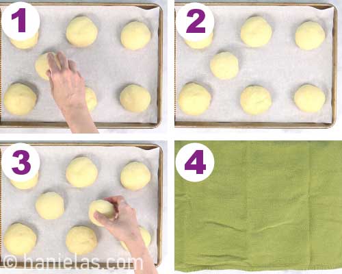 Covering buns on a baking sheet with a kitchen towel.