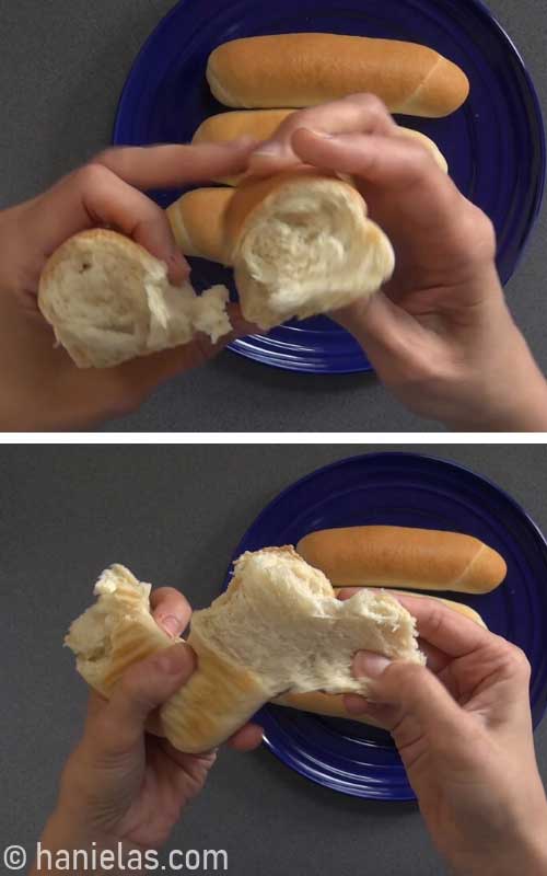 Tearing bread bun in half showing the texture and inside.