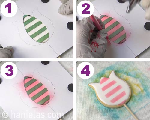 Airbrushing section of a cookie with astripe stencil.