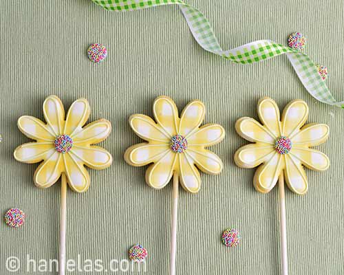 Decorated flower cookies on a table.