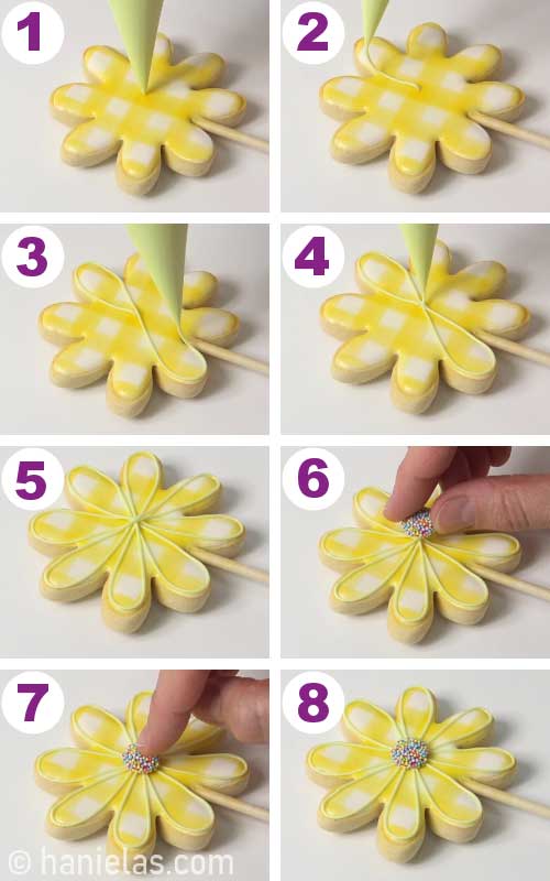 Outlining flower cookie with icing and attaching nonpareil flower center onto a cookie.