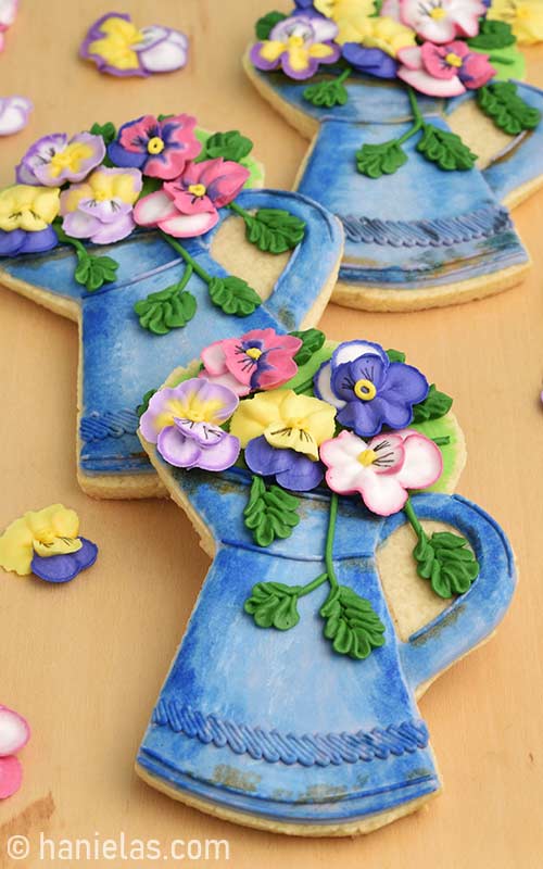 Decorated sugar cookies on a wood board.