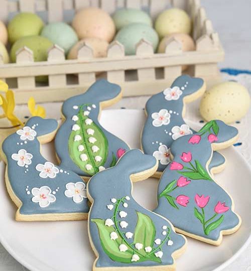 Wet on wet decorated sugar cookies on a plate.