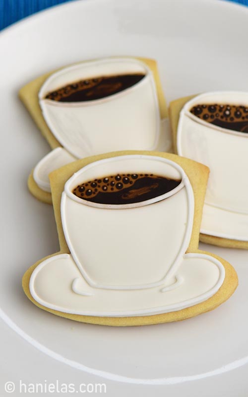 Decorated cup cookies on a plate.