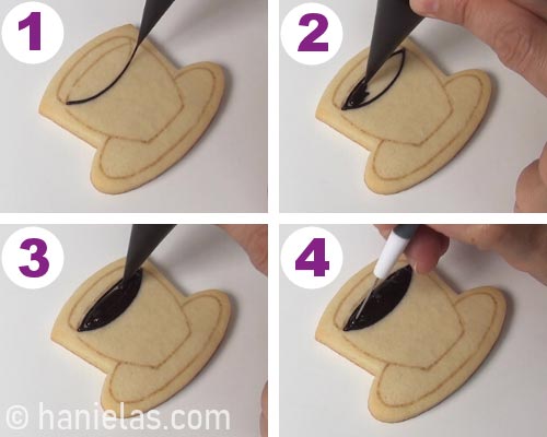 Outlining and flooding section with dark brown icing. Shaping it with a needle tool.