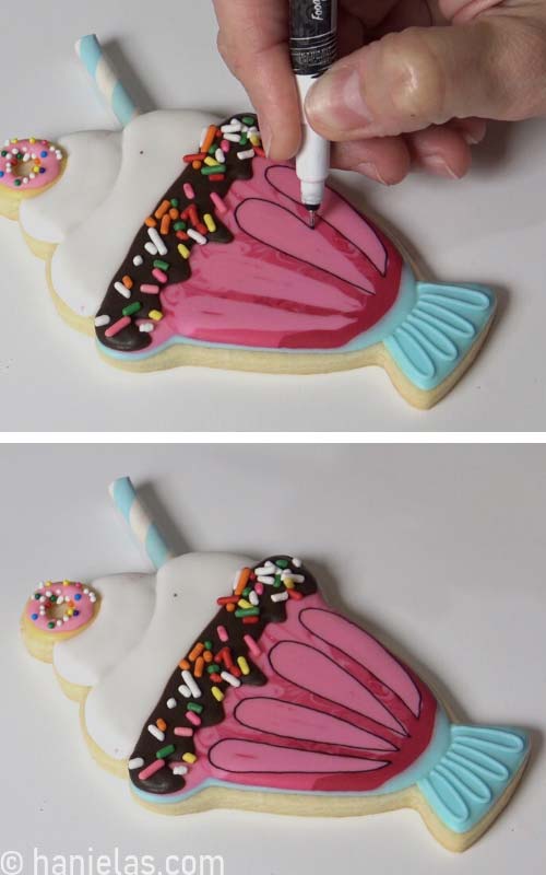 Outline dry icing designs with black edible marker.