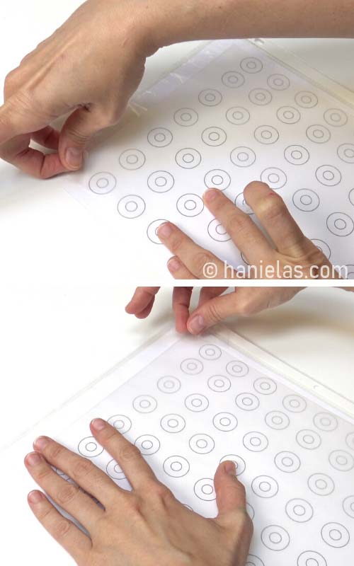 Taping wax paper onto a donut template.