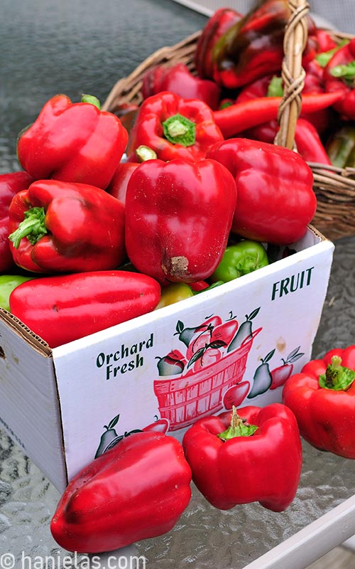 Bell peppers in a cardboard box.