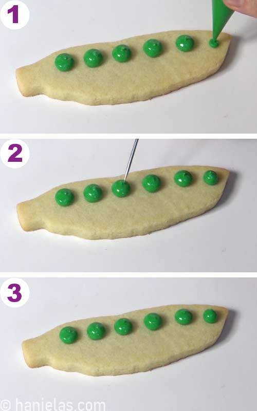 Piping large green dots on a cookie that looks like peas.