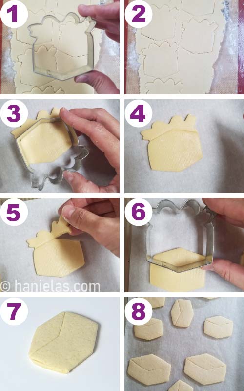 Cutting out cookies with a metal cookie cutter.