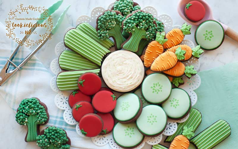 Mini decorated cookies arranged on a platter.