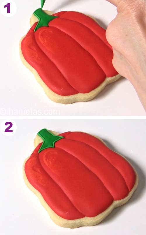 Outlining a stem on a pepper shaped cookie with a green icing.