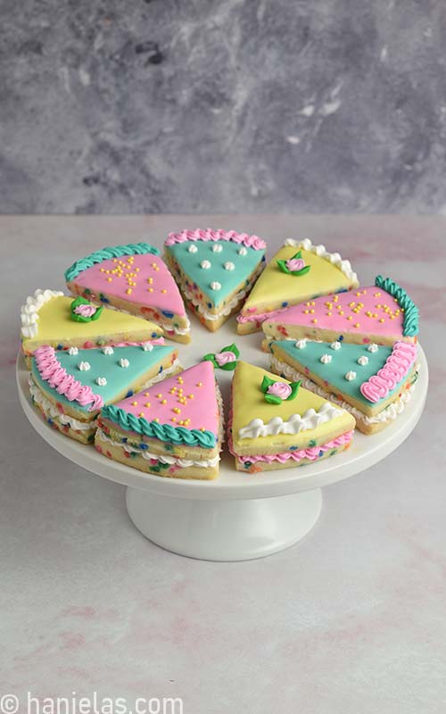 Decorated cookies on a cake stand.