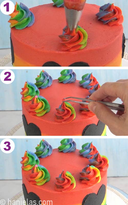 Piping rainbow buttercream swirls on top of the cake and decorating swirls with heart sprinkles.