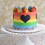 Decorated cake with rainbow buttercream frosting.