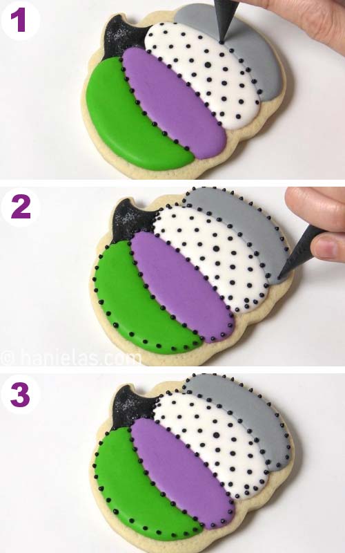 Piping small black dots with royal icing around each pumpkin segment.