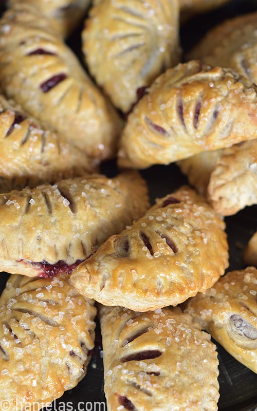 Baked hand pies with sugar crystals on the top.