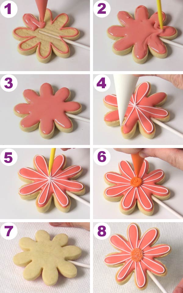 Flower cookies being flooded with royal icing.