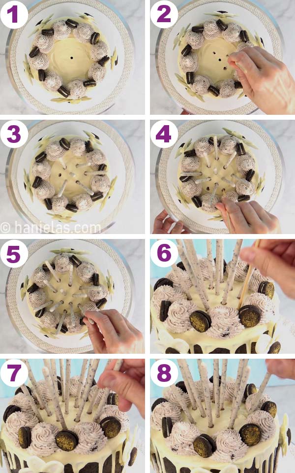 Hand inserting pocky sticks into the cake