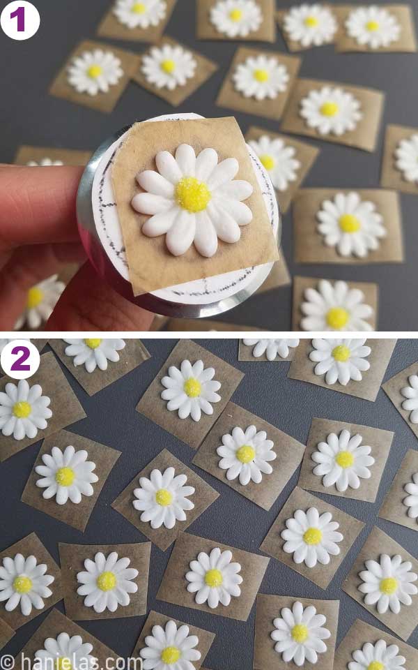 Hand holding a flower nail with a piped white daisy royal icing flower.