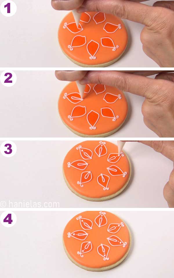 Piping teardrop shape outlines onto a orange iced cookie.