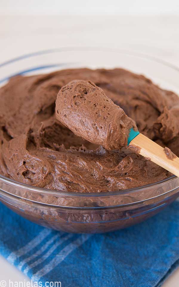 A glass bowl with chocolate buttercream.