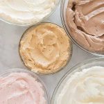 Five glass bowls filled with flavored buttercream.