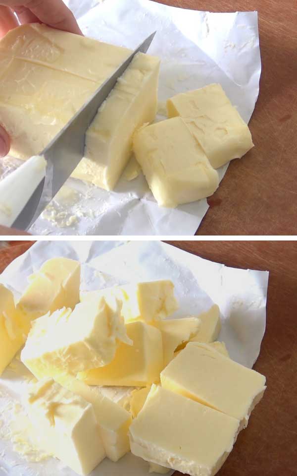 Slicing butter on a cutting board.