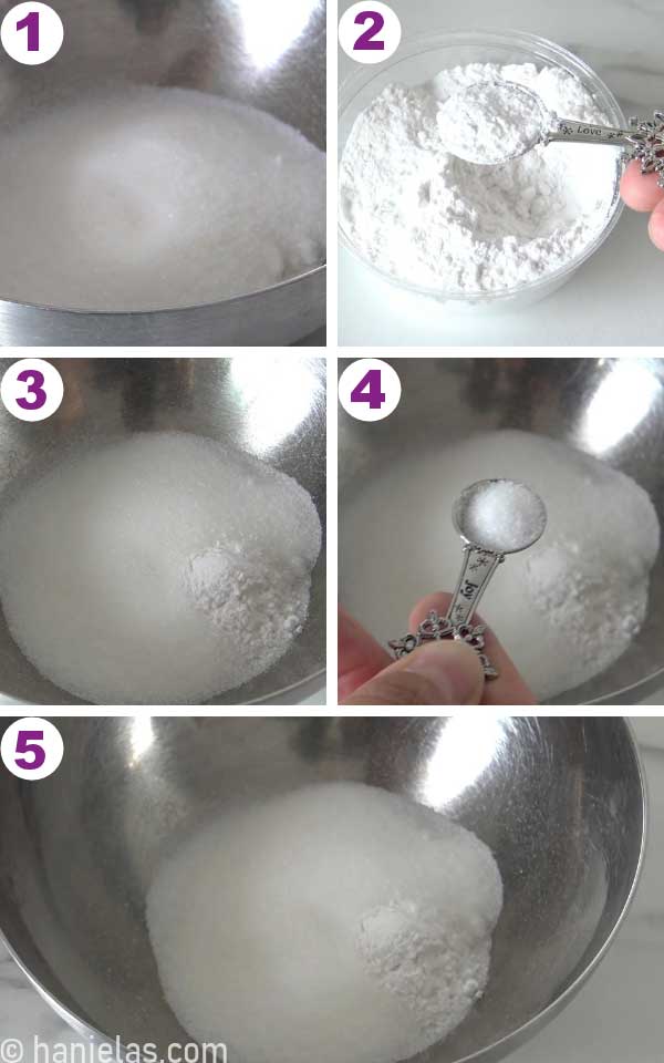 Stainless steel bowl with granulated sugar, fingers holding a measuring spoon with cream of tartar and salt over the bowl.